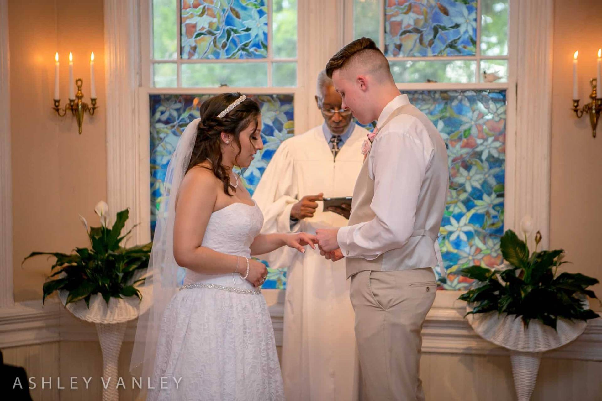 Couple exchanging wedding rings.
